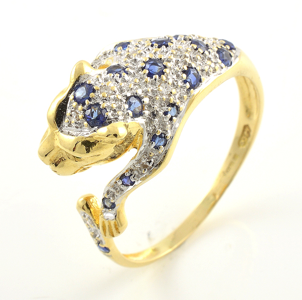 18ct gold sapphire and diamond panther ring with emerald eyes.